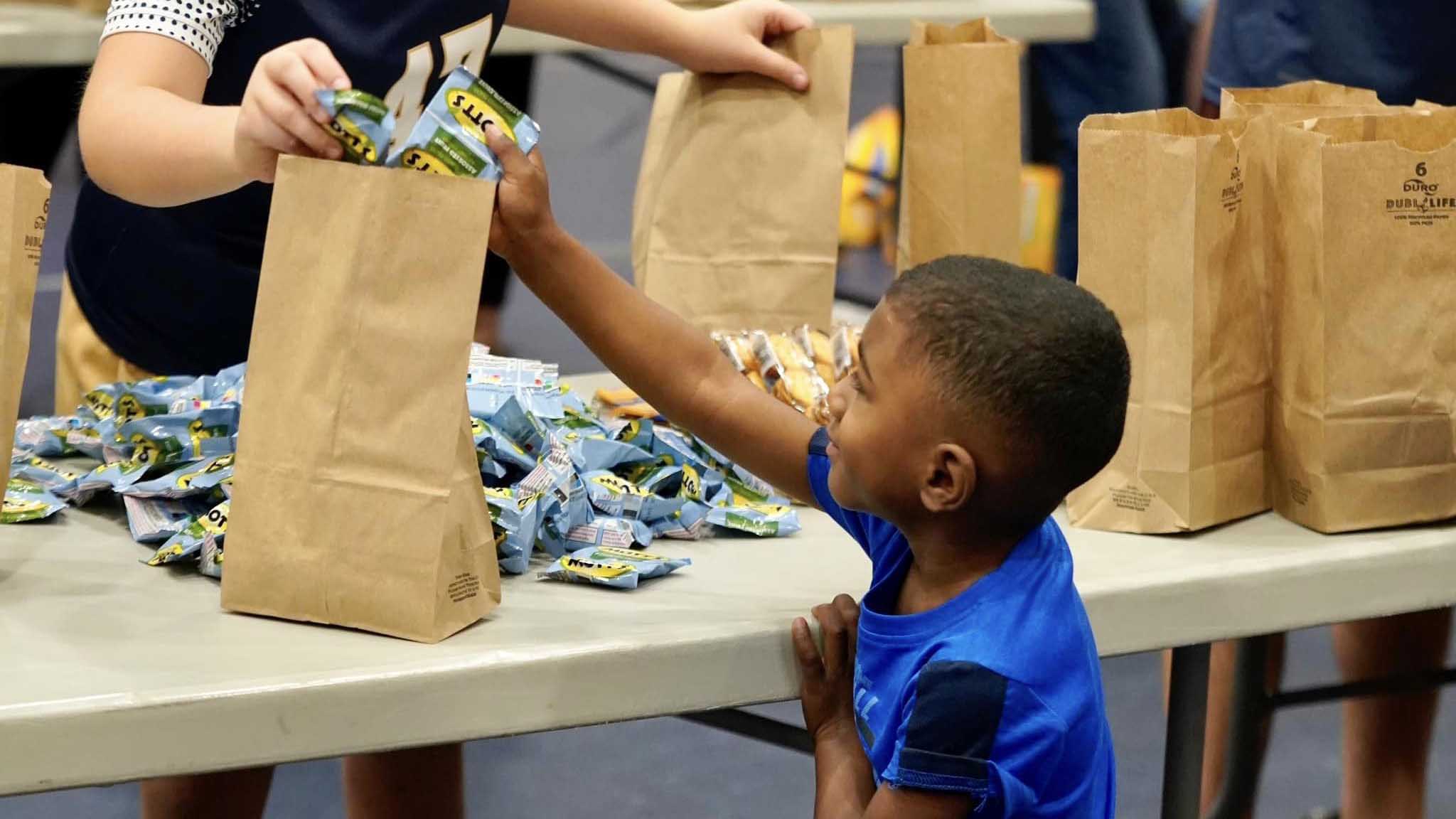 Family playing soccor with their child