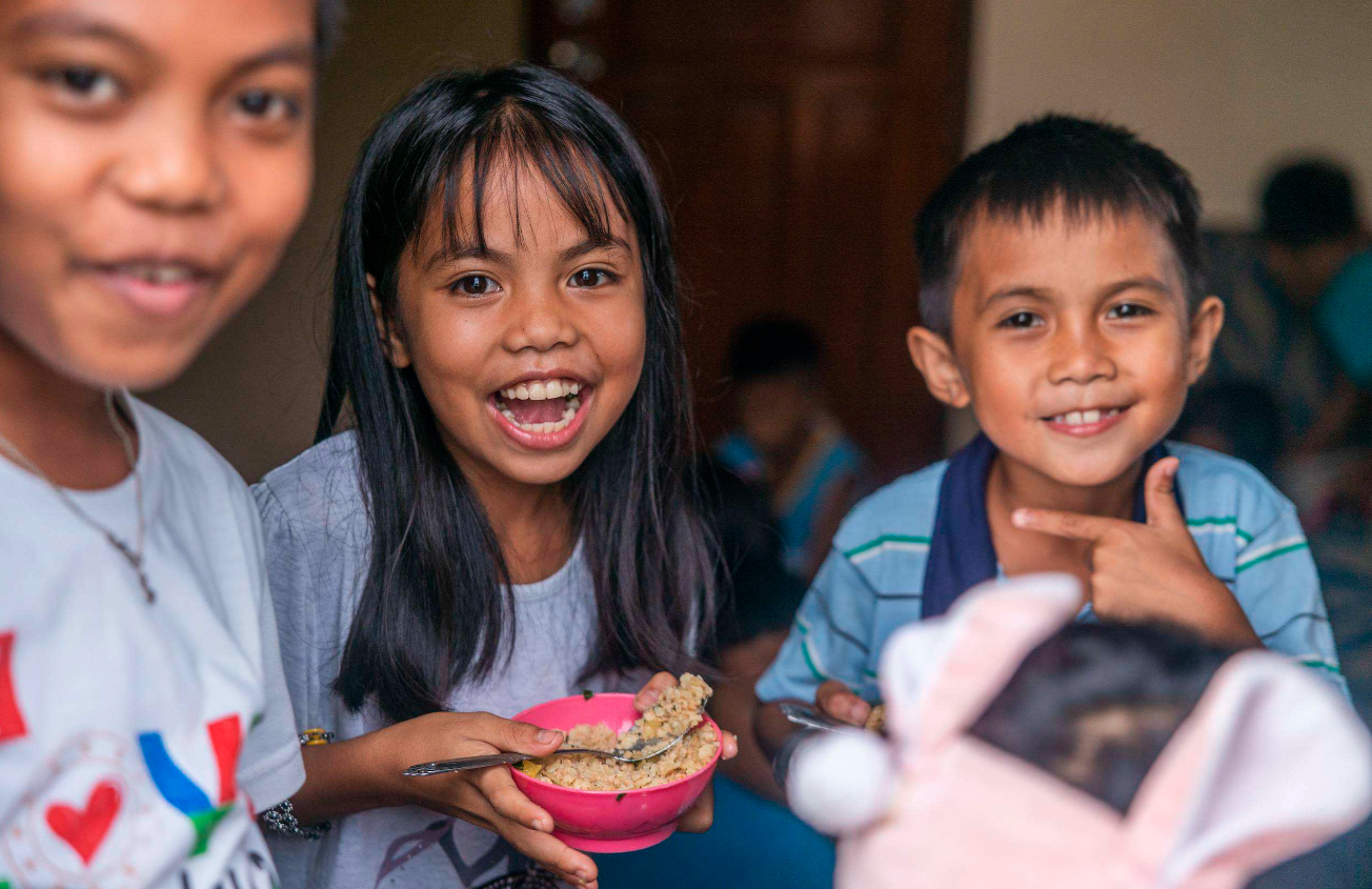 Group of young boys packing food bags