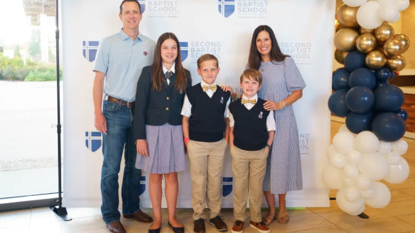 Group of parents and students next to stage