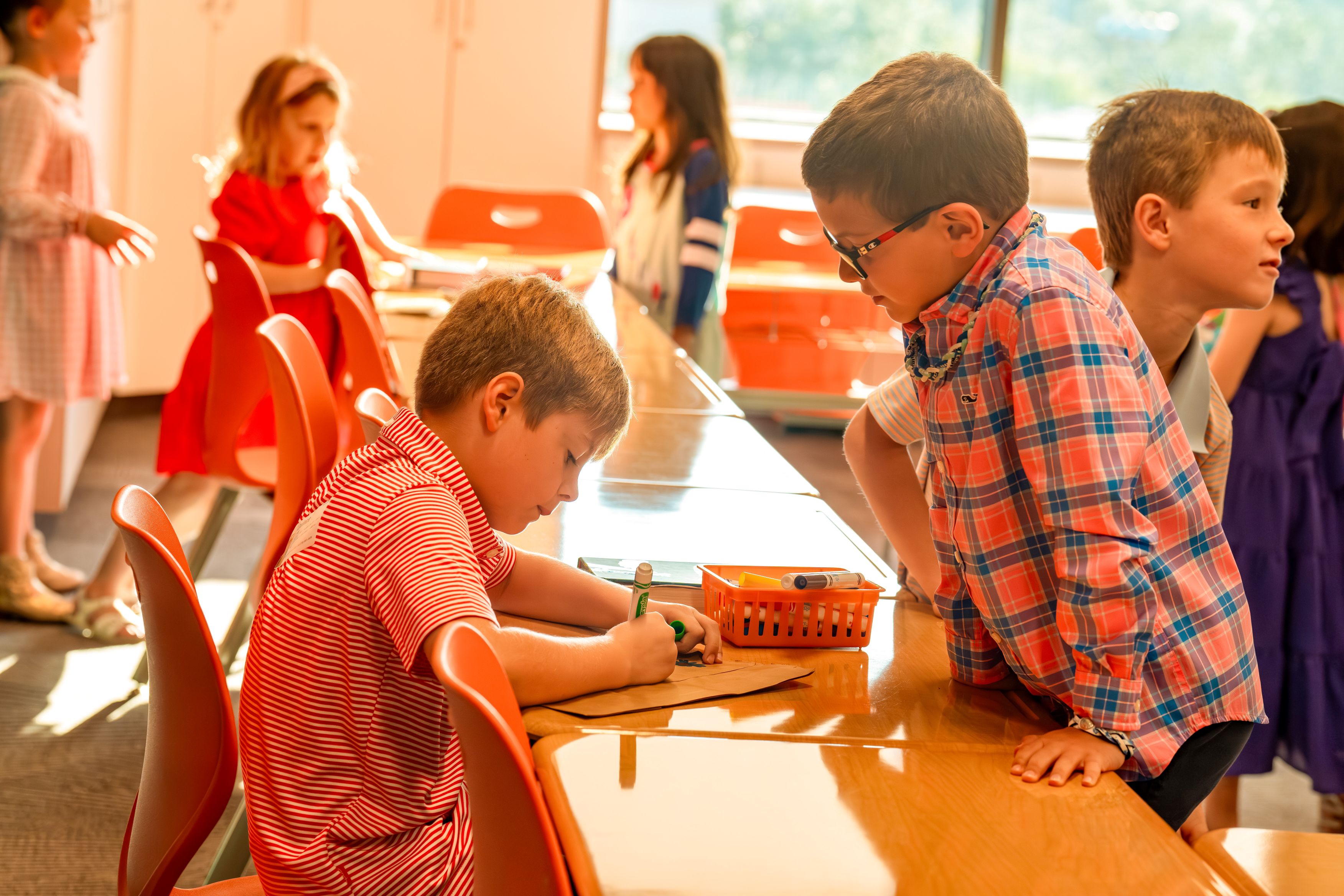 Two young boys looking at book